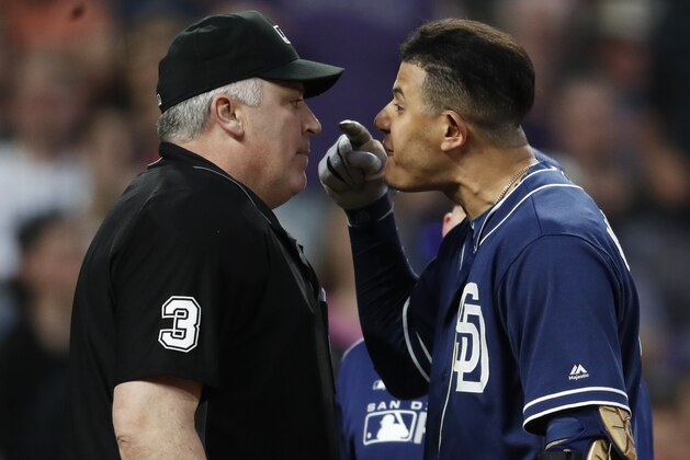 San Diego Padres shortstop Manny Machado, right, yells at home plate umpire Bill Welke, who had called Machado out on strikes during the fifth inning of the team's baseball game against the Colorado Rockies on Saturday, June 15, 2019, in Denver. (AP Photo/David Zalubowski)