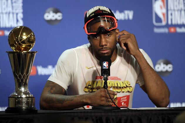 Toronto Raptors forward Kawhi Leonard speaks at a news conference alongside the NBA Finals Most Valuable Player trophy after the Raptors defeated the Golden State Warriors in Game 6 of basketball's NBA Finals in Oakland, Calif., Thursday, June 13, 2019. (AP Photo/Ben Margot)