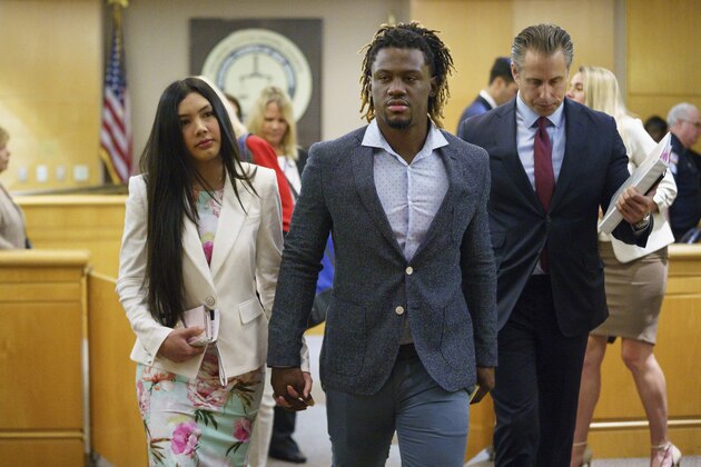 Philadelphia Phillies baseball player Odubel Herrera leaves a courtroom with an unidentified friend after a hearing on a domestic violence case in Atlantic City, N.J., Wednesday, July 3, 2019. (Jessica Griffin/The Philadelphia Inquirer via AP, Pool)