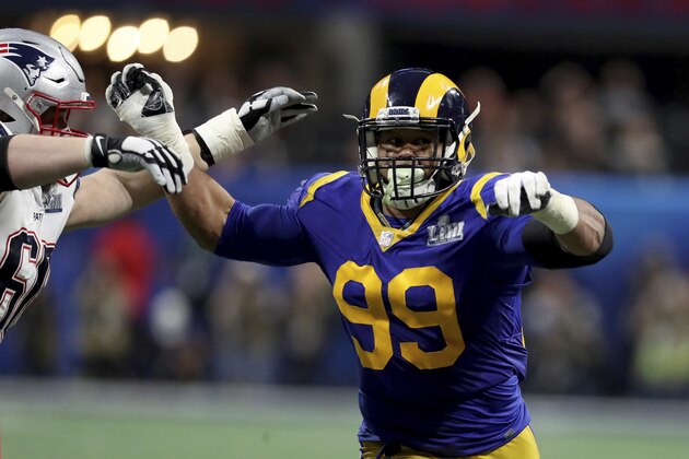 FILE - In this Feb. 3, 2019, file photo, Los Angeles Rams Aaron Donald (99) rushes against the New England Patriots during NFL Super Bowl 53 in Atlanta. Two-time reigning defensive player of the year Aaron Donald is always searching for out-of-the-box ways to improve his game. That's why the Rams defensive lineman trained with knives again this offseason. That's right, knives, of the plastic variety, of course, in order to improve his eye-hand coordination. His real driving force? That loss to the New England Patriots in the Super Bowl last February. (AP Photo/Gregory Payan, File)