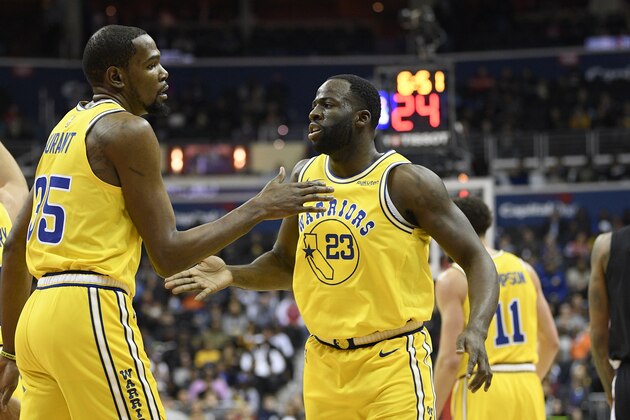 Golden State Warriors forward Draymond Green (23) reacts with forward Kevin Durant (35) during the first half of an NBA basketball game against the Washington Wizards, Thursday, Jan. 24, 2019, in Washington. (AP Photo/Nick Wass)