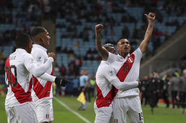 Peru's Victor Yotun, right, celebrates scoring his side's second goal with teammates during a Copa America semifinal soccer match against Chile at the Arena do Gremio in Porto Alegre, Brazil, Wednesday, July 3, 2019. (AP Photo/Ricardo Mazalan)