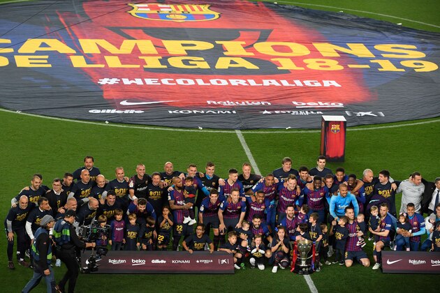 Barcelona team celebrates becoming La Liga champions after winning the Spanish League football match between FC Barcelona and Levante UD at the Camp Nou stadium in Barcelona on April 27, 2019. - Lionel Messi clinched an eighth La Liga title for Barcelona in 11 seasons today as he scored the only goal in a 1-0 win over Levante. It is the Catalan club's 26th league title -- second in Spain to Real Madrid's record of 33. (Photo by LLUIS GENE / AFP)        (Photo credit should read LLUIS GENE/AFP/Getty Images)