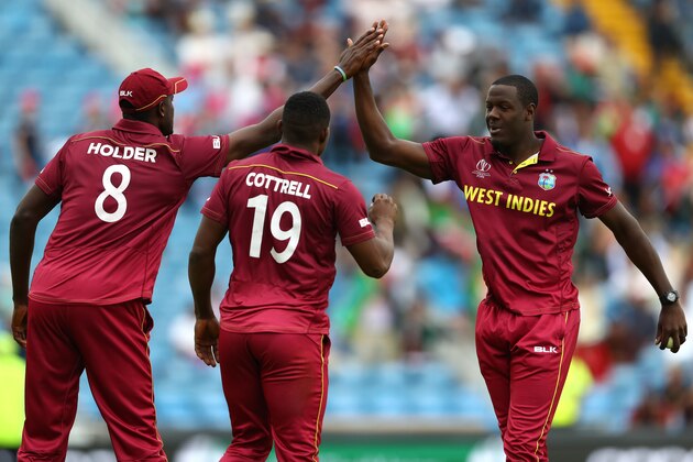 LEEDS, ENGLAND - JULY 04:  Carlos Brathwaite (r) of West Indies high fives Jason Holder after capturing the wicket of  Asghar Afghan during the Group Stage match of the ICC Cricket World Cup 2019 between Afghanistan and West Indies at Headingley on July 04, 2019 in Leeds, England. (Photo by Michael Steele/Getty Images)