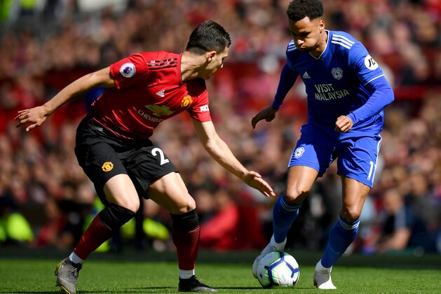 MANCHESTER, ENGLAND - MAY 12: Diogo Dalot of Manchester United battles for possession with Josh Murphy of Cardiff City during the Premier League match between Manchester United and Cardiff City at Old Trafford on May 12, 2019 in Manchester, United Kingdom. (Photo by Dan Mullan/Getty Images)