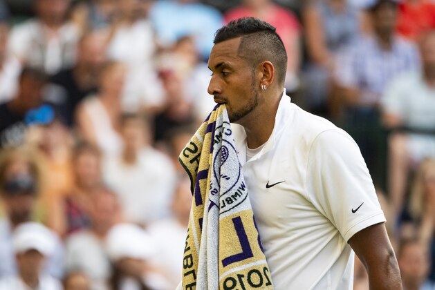 LONDON, ENGLAND - JULY 04: Nick Kyrgios of Australia walks onto court with his towel in his mouth after a change of ends during his match against Rafael Nadal of Spain during Day 4 of The Championships - Wimbledon 2019 at All England Lawn Tennis and Croquet Club on July 04, 2019 in London, England. (Photo by TPN/Getty Images)