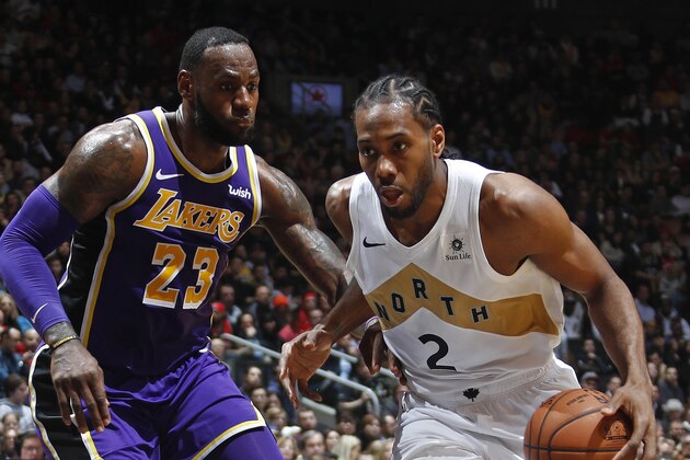 TORONTO, CANADA - MARCH 14: Kawhi Leonard #2 of the Toronto Raptors handles the ball against LeBron James #23 of the Los Angeles Lakers on March 14, 2019 at the Scotiabank Arena in Toronto, Ontario, Canada.  NOTE TO USER: User expressly acknowledges and agrees that, by downloading and or using this Photograph, user is consenting to the terms and conditions of the Getty Images License Agreement.  Mandatory Copyright Notice: Copyright 2019 NBAE (Photo by Mark Blinch/NBAE via Getty Images)