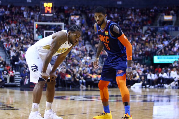 TORONTO, ON - MARCH 22:  Kawhi Leonard #2 of the Toronto Raptors and Paul George #13 of the Oklahoma City Thunder prepare for play to resume during the second half of an NBA game at Scotiabank Arena on March 22, 2019 in Toronto, Canada.  NOTE TO USER: User expressly acknowledges and agrees that, by downloading and or using this photograph, User is consenting to the terms and conditions of the Getty Images License Agreement.  (Photo by Vaughn Ridley/Getty Images)