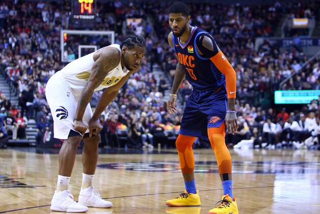 TORONTO, ON - MARCH 22:  Kawhi Leonard #2 of the Toronto Raptors and Paul George #13 of the Oklahoma City Thunder prepare for play to resume during the second half of an NBA game at Scotiabank Arena on March 22, 2019 in Toronto, Canada.  NOTE TO USER: User expressly acknowledges and agrees that, by downloading and or using this photograph, User is consenting to the terms and conditions of the Getty Images License Agreement.  (Photo by Vaughn Ridley/Getty Images)