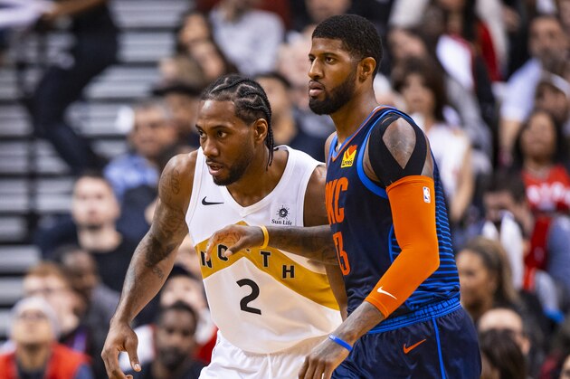 TORONTO, CANADA - MARCH 22:  Kawhi Leonard #2 of the Toronto Raptors and Paul George #13 of the Oklahoma City Thunder defend their positions during the game on March 22, 2019 at Scotiabank Arena in Toronto, Ontario, Canada. NOTE TO USER: User expressly acknowledges and agrees that, by downloading and/or using this photograph, user is consenting to the terms and conditions of the Getty Images License Agreement. Mandatory Copyright Notice: Copyright 2019 NBAE (Photo by Zach Beeker/NBAE via Getty Images)