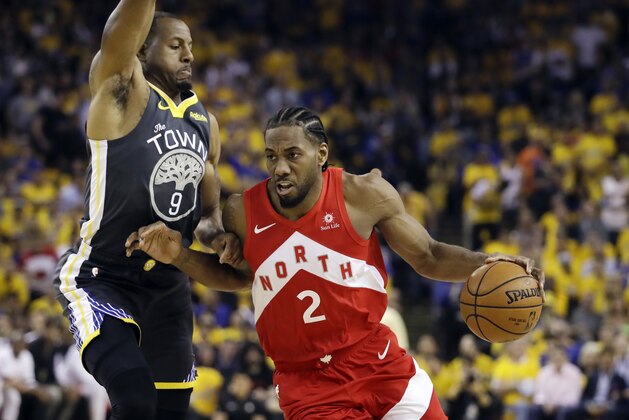 FILE - In this June 13, 2019, file photo, Toronto Raptors forward Kawhi Leonard (2) drives against Golden State Warriors forward Andre Iguodala (9) during the first half of Game 6 of basketball's NBA Finals in Oakland, Calif. A person familiar with the negotiations says the Los Angeles Clippers will be landing Kawhi Leonard as a free agent after they acquire Paul George from the Oklahoma City Thunder in a massive trade for players and draft picks. (AP Photo/Ben Margot, File)