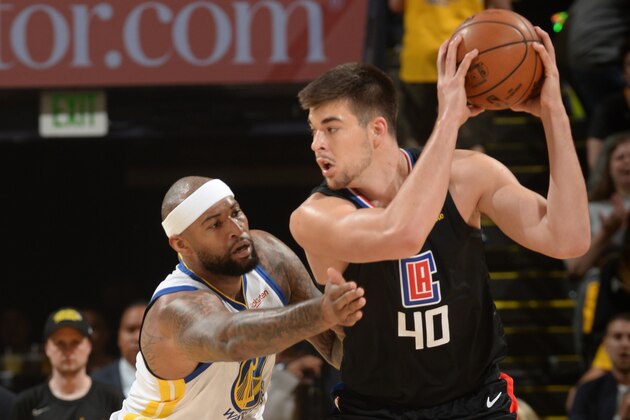 OAKLAND, CA - APRIL 13: Ivica Zubac #40 of the LA Clippers posts up on DeMarcus Cousins #0 of the Golden State Warriors during Game One of Round One of the 2019 NBA Playoffs on April 13, 2019 at ORACLE Arena in Oakland, California. NOTE TO USER: User expressly acknowledges and agrees that, by downloading and or using this photograph, user is consenting to the terms and conditions of Getty Images License Agreement. Mandatory Copyright Notice: Copyright 2019 NBAE (Photo by Noah Graham/NBAE via Getty Images)