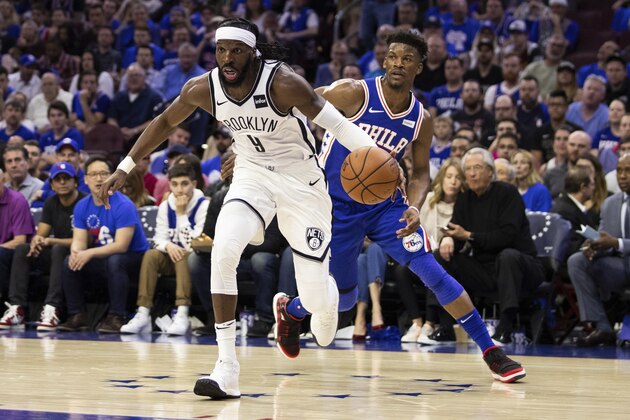Brooklyn Nets' DeMarre Carroll, left, drives to the basket against Philadelphia 76ers' Jimmy Butler, right, during the second half in Game 1 of a first-round NBA basketball playoff series, Saturday, April 13, 2019, in Philadelphia. Nets won 111-102. (AP Photo/Chris Szagola)