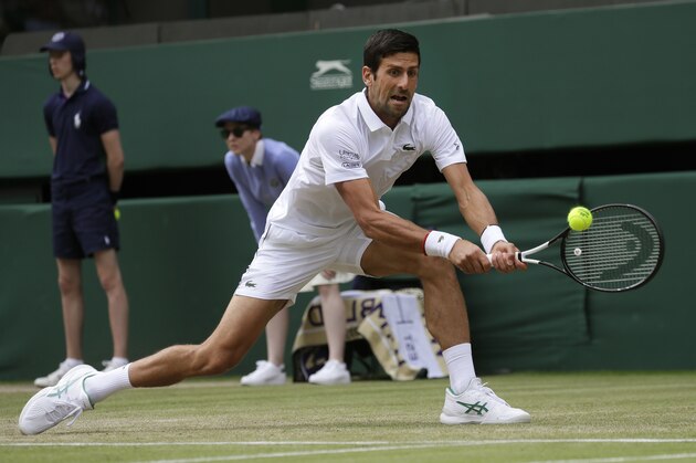 Serbia's Novak Djokovic returns to Poland's Hubert Hurakacz in a Men's singles match during day five of the Wimbledon Tennis Championships in London, Friday, July 5, 2019. (AP Photo/Kirsty Wigglesworth)