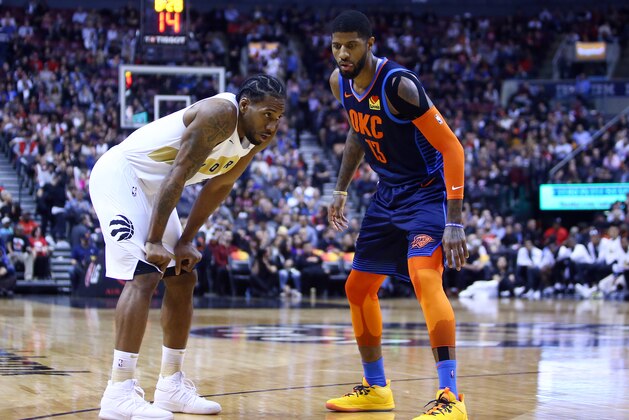TORONTO, ON - MARCH 22:  Kawhi Leonard #2 of the Toronto Raptors and Paul George #13 of the Oklahoma City Thunder prepare for play to resume during the second half of an NBA game at Scotiabank Arena on March 22, 2019 in Toronto, Canada.  NOTE TO USER: User expressly acknowledges and agrees that, by downloading and or using this photograph, User is consenting to the terms and conditions of the Getty Images License Agreement.  (Photo by Vaughn Ridley/Getty Images)