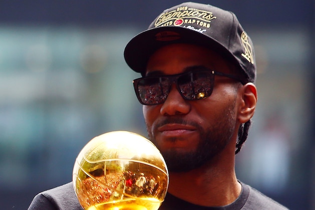 TORONTO, ON - JUNE 17:  Kawhi Leonard #2 of the Toronto Raptors holds the MVP trophy during the Toronto Raptors Victory Parade on June 17, 2019 in Toronto, Canada. The Toronto Raptors beat the Golden State Warriors 4-2 to win the 2019 NBA Finals.  NOTE TO USER: User expressly acknowledges and agrees that, by downloading and or using this photograph, User is consenting to the terms and conditions of the Getty Images License Agreement.  (Photo by Vaughn Ridley/Getty Images)