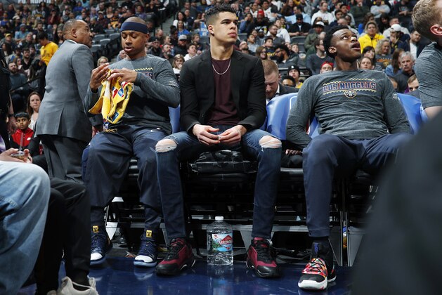 Denver Nuggets guard Isaiah Thomas, left, sits on the bench with injured rookie forward Michael Porter Jr. and forward Jarred Vanderbilt during the first half of the team's NBA basketball game against the Dallas Mavericks on Thursday, March 14, 2019, in Denver. (AP Photo/David Zalubowski)