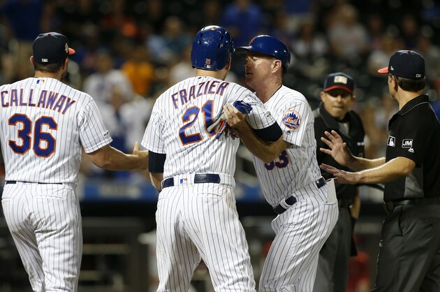 NEW YORK, NEW YORK - JULY 06:   Todd Frazier #21 of the New York Mets is held back by first base coach Glenn Sherlock #53 as he argues with the umpires after being ejected during the fifth inning against the Philadelphia Phillies at Citi Field on July 06, 2019 in New York City. (Photo by Jim McIsaac/Getty Images)