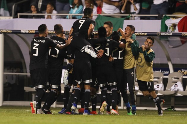 CHICAGO, IL - JULY 07: Jonathan dos Santos of Mexico celebrates with his teammates after scoring a goal to make it 1-0 during the 2019 CONCACAF Gold Cup Final between Mexico and United States of America at Soldier Field on July 7, 2019 in Chicago, Illinois. (Photo by Matthew Ashton - AMA/Getty Images)