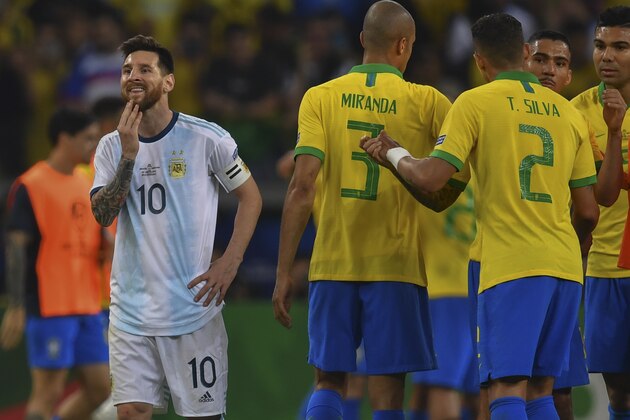 Argentina's Lionel Messi (L) gestures after losing 2-0 to Brazil at the end of their Copa America football tournament semi-final match at the Mineirao Stadium in Belo Horizonte, Brazil, on July 2, 2019. (Photo by Pedro UGARTE / AFP)        (Photo credit should read PEDRO UGARTE/AFP/Getty Images)