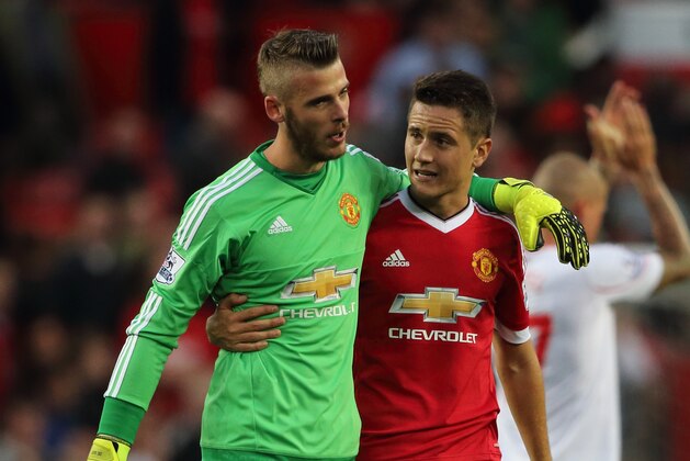 MANCHESTER, ENGLAND - SEPTEMBER 12:  David De Gea of Manchester United walks off with Ander Herrera of Manchester United after the 3-1 victory in the Barclays Premier League match between Manchester United and Liverpool on September 12, 2015 in Manchester, United Kingdom.  (Photo by Matthew Ashton - AMA/Getty Images)