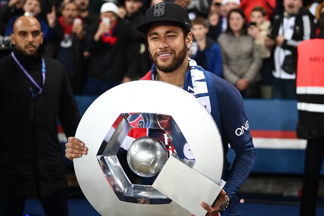 TOPSHOT - Paris Saint-Germain's Brazilian forward Neymar celebrates with the champion's trophy at the end of the French L1 football match between Paris Saint-Germain (PSG) and Dijon at the Parc des Princes stadium in Paris on May 18, 2019. (Photo by FRANCK FIFE / AFP)        (Photo credit should read FRANCK FIFE/AFP/Getty Images)
