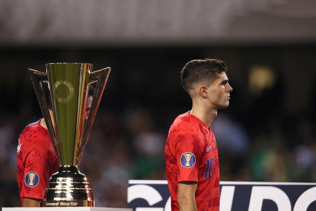 CHICAGO, IL - JULY 07: Christian Pulisic of USA walks past the CONCACAF Gold Cup trophy after USA's 0-1 defeat to Mexico in the 2019 CONCACAF Gold Cup Final between Mexico and United States of America at Soldier Field on July 7, 2019 in Chicago, Illinois. (Photo by Matthew Ashton - AMA/Getty Images)