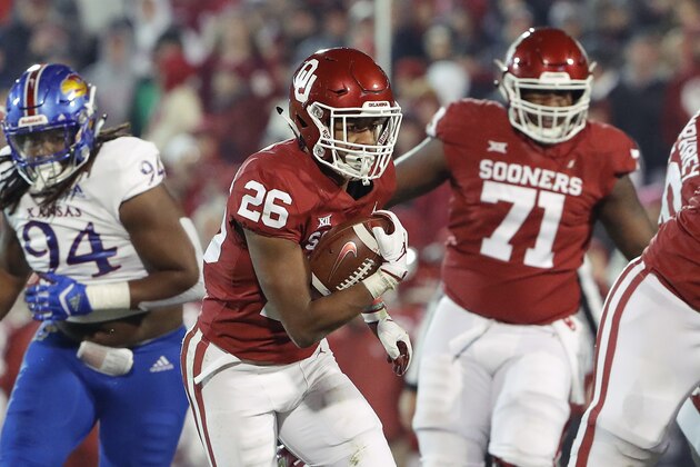 Oklahoma running back Kennedy Brooks (26) runs against Kansas during the second half of an NCAA college football game in Norman, Okla., Saturday, Nov. 17, 2018. Oklahoma won 55-40. (AP Photo/Alonzo Adams)