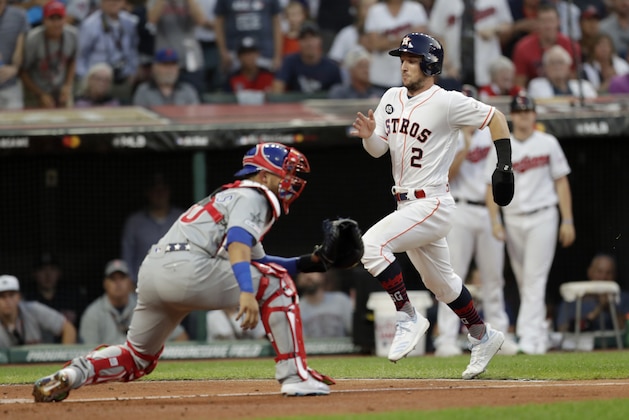 American League's Alex Bregman (2), of the Houston Astros, scores past National League catcher Willson Contreras, of the Chicago Cubs, during the second inning of the MLB baseball All-Star Game, Tuesday, July 9, 2019, in Cleveland. (AP Photo/Tony Dejak)