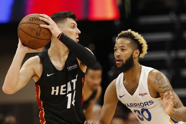 Miami Heat guard Tyler Herro, left, looks to pass against Golden State Warriors guard Ky Bowman during the second half of an NBA basketball summer league game in Sacramento, Calif., Wednesday, July 3, 2019. The Heat won 73-65. (AP Photo/Rich Pedroncelli)