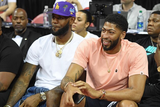 LAS VEGAS, NEVADA - JULY 05:  NBA players LeBron James (L) and Anthony Davis watch a game between the New Orleans Pelicans and the New York Knicks during the 2019 NBA Summer League at the Thomas & Mack Center on July 5, 2019 in Las Vegas, Nevada. NOTE TO USER: User expressly acknowledges and agrees that, by downloading and or using this photograph, User is consenting to the terms and conditions of the Getty Images License Agreement.  (Photo by Ethan Miller/Getty Images)