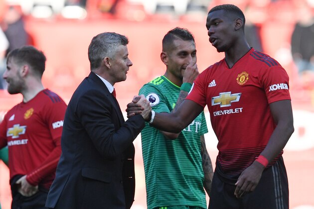 Manchester United's Norwegian manager Ole Gunnar Solskjaer (L) shakes hands with Manchester United's French midfielder Paul Pogba (R) after the final whistle of the English Premier League football match between Manchester United and Watford at Old Trafford in Manchester, north west England, on March 30, 2019. (Photo by Paul ELLIS / AFP) / RESTRICTED TO EDITORIAL USE. No use with unauthorized audio, video, data, fixture lists, club/league logos or 'live' services. Online in-match use limited to 120 images. An additional 40 images may be used in extra time. No video emulation. Social media in-match use limited to 120 images. An additional 40 images may be used in extra time. No use in betting publications, games or single club/league/player publications. /         (Photo credit should read PAUL ELLIS/AFP/Getty Images)