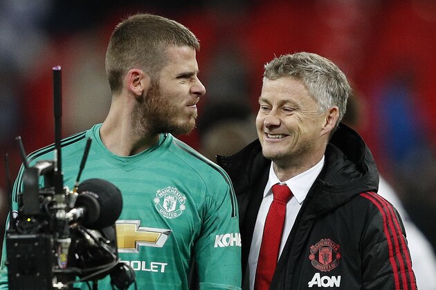 Manchester United's Spanish goalkeeper David de Gea (L) jokes with Manchester United's  Norwegian caretaker manager Ole Gunnar Solskjaer following the English Premier League football match between Tottenham Hotspur and Manchester United at Wembley Stadium in London, on January 13, 2019. - Manchester United won 1-0. (Photo by Adrian DENNIS / AFP) / RESTRICTED TO EDITORIAL USE. No use with unauthorized audio, video, data, fixture lists, club/league logos or 'live' services. Online in-match use limited to 120 images. An additional 40 images may be used in extra time. No video emulation. Social media in-match use limited to 120 images. An additional 40 images may be used in extra time. No use in betting publications, games or single club/league/player publications. /         (Photo credit should read ADRIAN DENNIS/AFP/Getty Images)