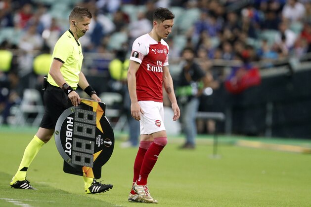 Arsenal's Mesut Ozil leaves the field after being substituted during the Europa League Final soccer match between Chelsea and Arsenal at the Olympic stadium in Baku, Azerbaijan, Thursday, May 30, 2019. (AP Photo/Darko Bandic)