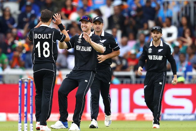 MANCHESTER, ENGLAND - JULY 10:  Trent Boult and Jimmy Neesham of New Zealand celebrates the wicket of Ravindra Jadeja of India during resumption of the Semi-Final match of the ICC Cricket World Cup 2019 between India and New Zealand after weather affected play at Old Trafford on July 10, 2019 in Manchester, England. (Photo by Michael Steele/Getty Images)