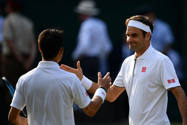 Switzerland's Roger Federer (R) shakes hands with Japan's Kei Nishikori (L) after Federer won their men's singles quarter-final match on day nine of the 2019 Wimbledon Championships at The All England Lawn Tennis Club in Wimbledon, southwest London, on July 10, 2019. (Photo by Daniel LEAL-OLIVAS / AFP) / RESTRICTED TO EDITORIAL USE        (Photo credit should read DANIEL LEAL-OLIVAS/AFP/Getty Images)