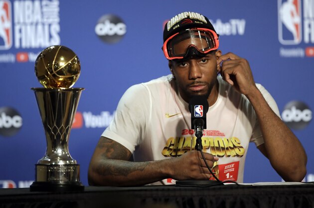 Toronto Raptors forward Kawhi Leonard speaks at a news conference alongside the NBA Finals Most Valuable Player trophy after the Raptors defeated the Golden State Warriors in Game 6 of basketball's NBA Finals in Oakland, Calif., Thursday, June 13, 2019. (AP Photo/Ben Margot)