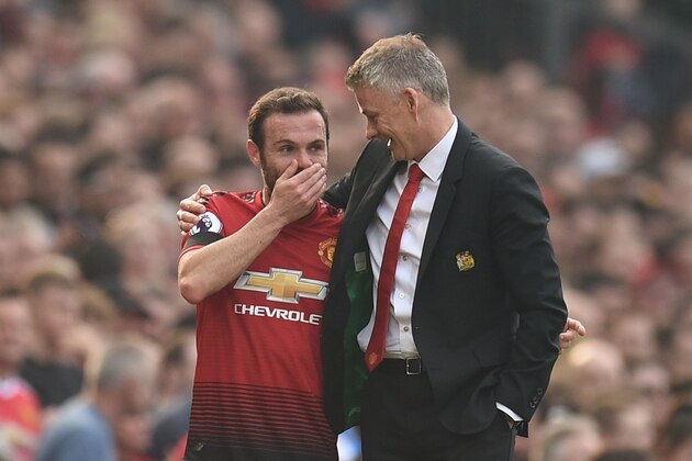 Manchester United's Spanish midfielder Juan Mata (L) talks with Manchester United's  Norwegian caretaker manager Ole Gunnar Solskjaer (R) after going off injured during the English Premier League football match between Manchester United and Liverpool at Old Trafford in Manchester, north west England, on February 24, 2019. (Photo by Oli SCARFF / AFP) / RESTRICTED TO EDITORIAL USE. No use with unauthorized audio, video, data, fixture lists, club/league logos or 'live' services. Online in-match use limited to 120 images. An additional 40 images may be used in extra time. No video emulation. Social media in-match use limited to 120 images. An additional 40 images may be used in extra time. No use in betting publications, games or single club/league/player publications. /         (Photo credit should read OLI SCARFF/AFP/Getty Images)