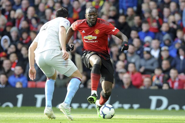 Manchester United's Romelu Lukaku vies for the ball with West Ham's Fabian Balbuena, left, during the English Premier League soccer match between Manchester United and West Ham United at Old Trafford in Manchester, England, Saturday, April 13, 2019. (AP Photo/Rui Vieira)