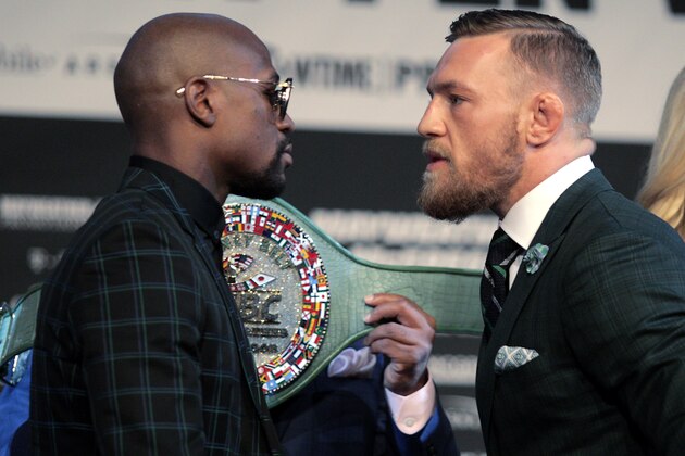 Boxer Floyd Mayweather Jr. (L) and MMA figher Connor Mcgregor face-off during a media press conference August 23, 2017 at the MGM Grand in Las Vegas, Nevada. 
Mayweather, the 40-year-old undefeated former welterweight boxing champion, has been lured out of retirement to face McGregor, a star of mixed martial arts' Ultimate Fighting Championship. The two men meet in a 12-round contest under boxing rules on August 26th that is tipped to become the richest fight in history.
 / AFP PHOTO / John Gurzinski        (Photo credit should read JOHN GURZINSKI/AFP/Getty Images)