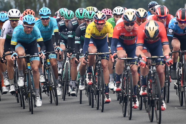 Bahrain-Merida rider Belgium's Dylan Teuns (C), wearing the overall leader's yellow jersey, rides with the pack towards the end of the third stage of the 71st edition of the Criterium du Dauphine cycling race, 177 km between Le Puy-en-Velay and Riom on June 11, 2019. (Photo by Anne-Christine POUJOULAT / AFP)        (Photo credit should read ANNE-CHRISTINE POUJOULAT/AFP/Getty Images)