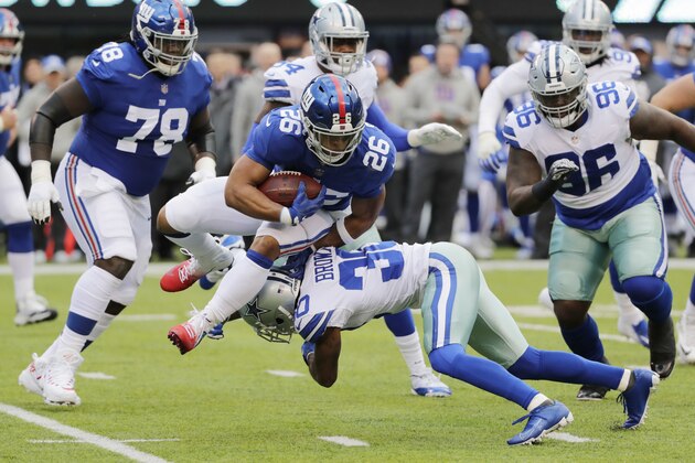 New York Giants' Saquon Barkley, top, is hit by Dallas Cowboys' Anthony Brown during the first half of an NFL football game, Sunday, Dec. 30, 2018, in East Rutherford, N.J. (AP Photo/Frank Franklin II)