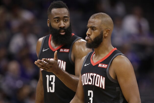 Houston Rockets guard James Harden, left, talks with teammate Chris Paul as they walk off the court during a timeout in the second half of an NBA basketball game against the Sacramento Kings, Tuesday, April 2, 2019, in Sacramento, Calif. The Rockets won 130-105. (AP Photo/Rich Pedroncelli)