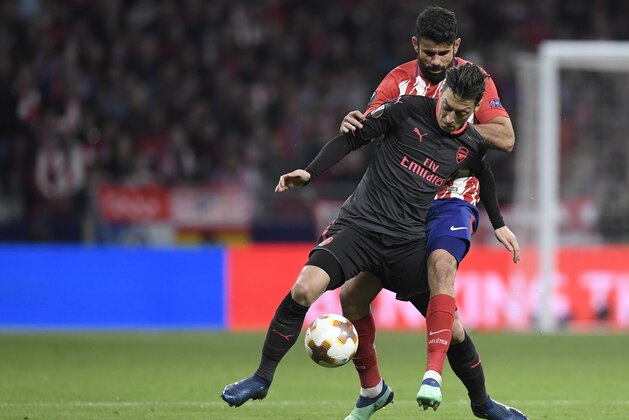 Arsenal's German midfielder Mesut Ozil (L) vies with Atletico Madrid's Spanish forward Diego Costa during the UEFA Europa League semi-final second leg football match between Club Atletico de Madrid and Arsenal FC at the Wanda Metropolitano stadium in Madrid on May 3, 2018.. (Photo by GABRIEL BOUYS / AFP)        (Photo credit should read GABRIEL BOUYS/AFP/Getty Images)