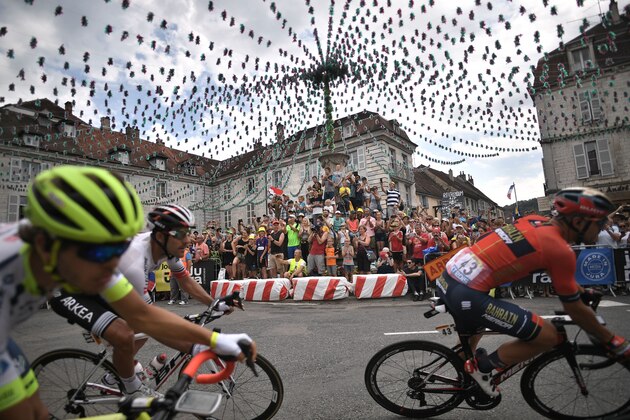 Cyclsim enthusiasts applaud cyclists crossing a square of Arbois, eastern France, during the seventh stage of the 106th edition of the Tour de France cycling race between Belfort and Chalon-sur-Saone, on July 12, 2019. (Photo by Marco Bertorello / AFP)        (Photo credit should read MARCO BERTORELLO/AFP/Getty Images)