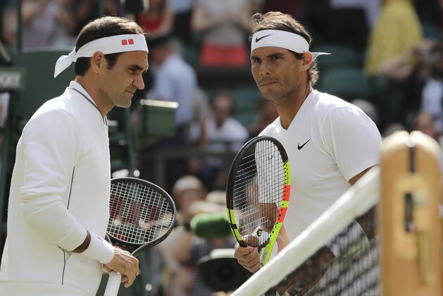 Spain's Rafael Nadal and Switzerland's Roger Federer, left, pose before a men's singles semifinal match on day eleven of the Wimbledon Tennis Championships in London, Friday, July 12, 2019. (AP Photo/Ben Curtis)