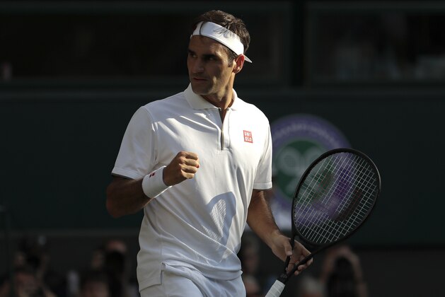 Switzerland's Roger Federer celebrates winning a point against Spain's Rafael Nadal during a men's singles semifinal match on day eleven of the Wimbledon Tennis Championships in London, Friday, July 12, 2019. (AP Photo/Ben Curtis)