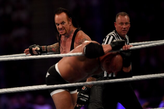 World Wrestling Entertainment star The Undertaker (L) competes against Goldberg (C) during the World Wrestling Entertainment (WWE) Super Showdown event in the Saudi Red Sea port city of Jeddah late on January 7, 2019. (Photo by Amer HILABI / AFP)        (Photo credit should read AMER HILABI/AFP/Getty Images)