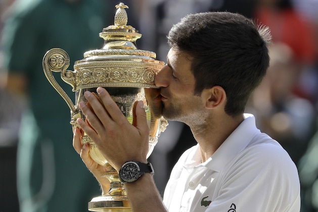 FILE - In this July 15, 2018, file photo, Serbia's Novak Djokovic holds the trophy after winning the men's singles final against Kevin Anderson, of South Africa, at the Wimbledon Tennis Championships in London. Djokovic is the men's No. 6 seed at this year's U.S. Open, which starts Monday. (AP Photo/Kirsty Wigglesworth, File)