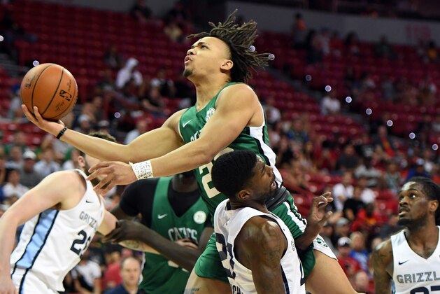 LAS VEGAS, NEVADA - JULY 11:  Carsen Edwards #29 of the Boston Celtics is fouled as he drives against Shaq Buchanan #27 of the Memphis Grizzlies during the 2019 NBA Summer League at the Thomas & Mack Center on July 11, 2019 in Las Vegas, Nevada. The Celtics defeated the Grizzlies 113-87. NOTE TO USER: User expressly acknowledges and agrees that, by downloading and or using this photograph, User is consenting to the terms and conditions of the Getty Images License Agreement.  (Photo by Ethan Miller/Getty Images)
